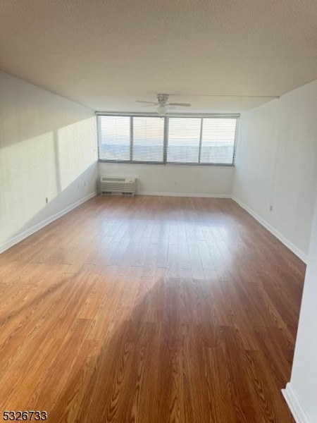 spare room featuring hardwood / wood-style floors and ceiling fan