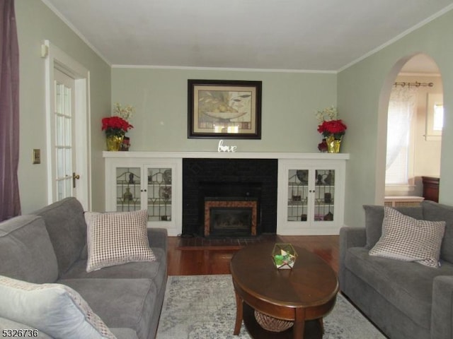 living room with dark hardwood / wood-style flooring and ornamental molding