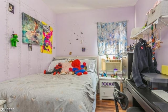 bedroom with hardwood / wood-style floors and cooling unit