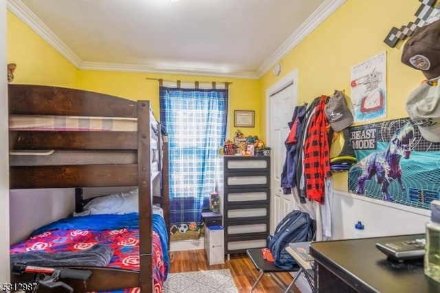 bedroom with crown molding and wood-type flooring