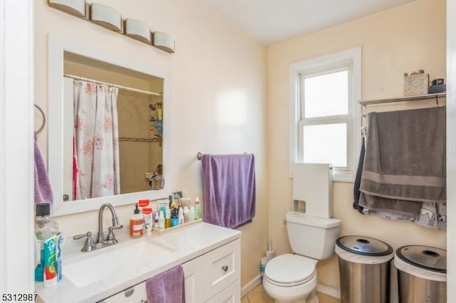 bathroom featuring curtained shower, toilet, and sink