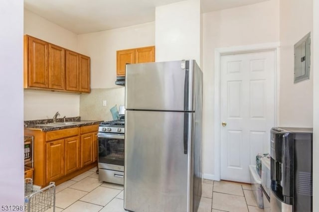 kitchen with electric panel, light tile patterned floors, sink, and appliances with stainless steel finishes