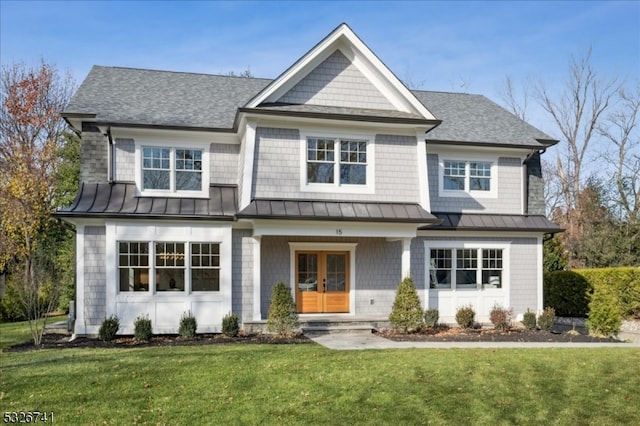 view of front of property featuring french doors, a porch, and a front lawn