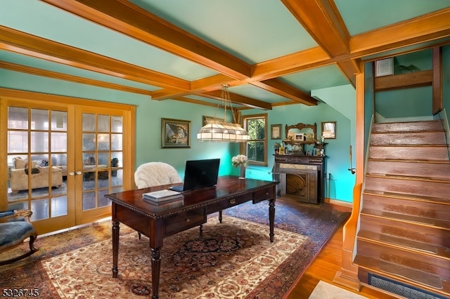 home office with beam ceiling, a wealth of natural light, french doors, and wood-type flooring