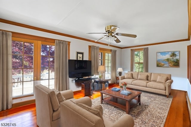 living room featuring french doors, light hardwood / wood-style floors, ceiling fan, and crown molding