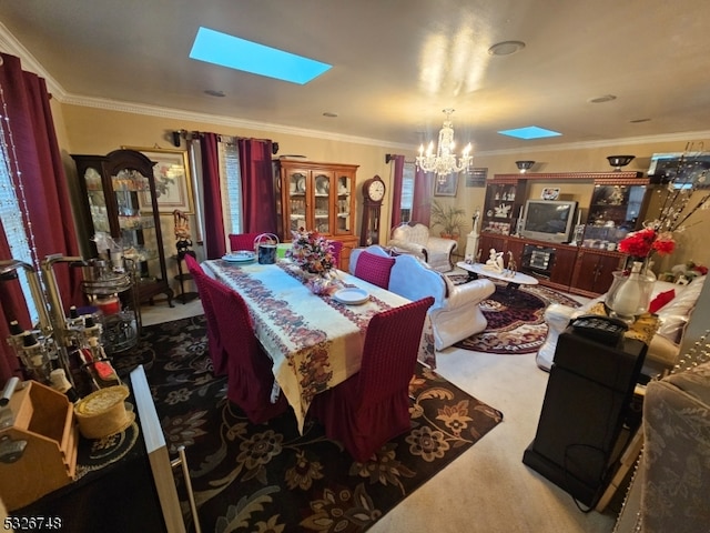 dining room with carpet, crown molding, a skylight, a notable chandelier, and a healthy amount of sunlight