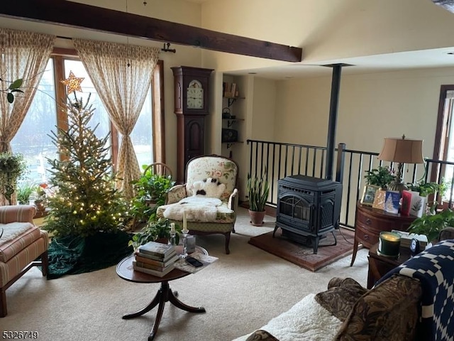 living room with carpet flooring and a wood stove