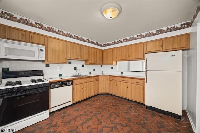 kitchen with decorative backsplash, white appliances, and sink