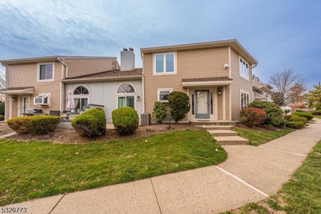 view of front property featuring central AC and a front lawn