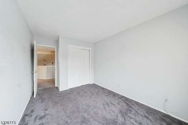 unfurnished bedroom featuring carpet and a closet