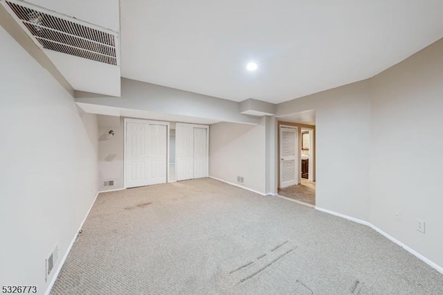 unfurnished bedroom featuring light carpet