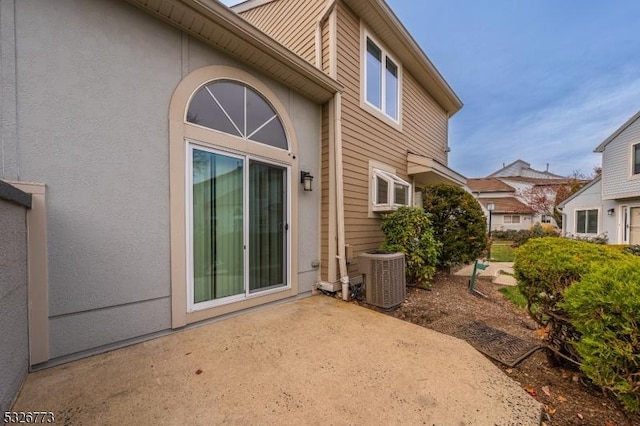 back of house with central air condition unit and a patio area