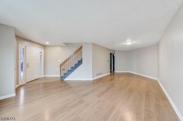 interior space with light hardwood / wood-style floors and a textured ceiling