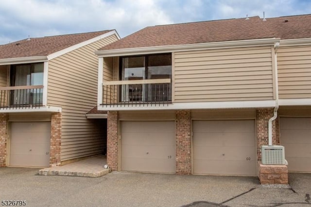 view of front of home with a balcony and a garage