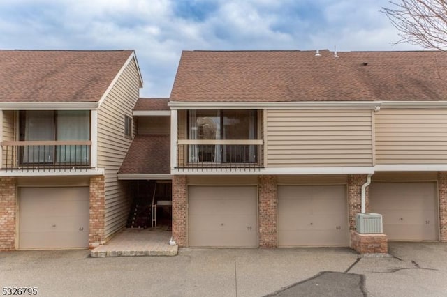 townhome / multi-family property featuring a balcony and central air condition unit