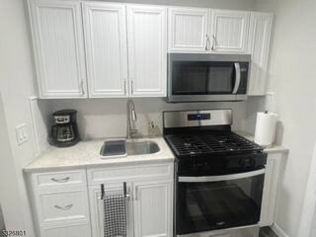 kitchen featuring white cabinetry, sink, and stainless steel appliances