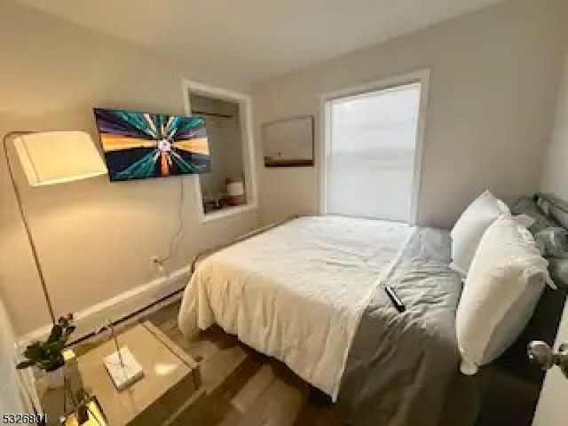 bedroom featuring dark hardwood / wood-style flooring