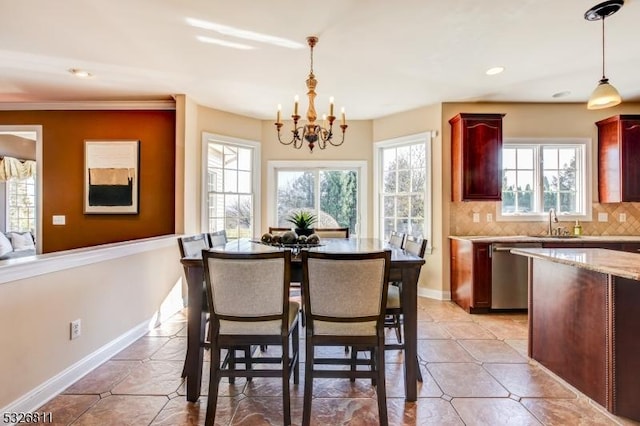 dining space with light tile patterned flooring, an inviting chandelier, and sink