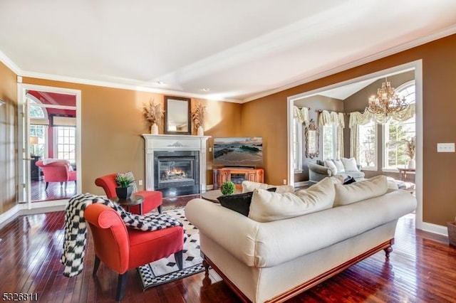 living room featuring a chandelier, wood-type flooring, and crown molding