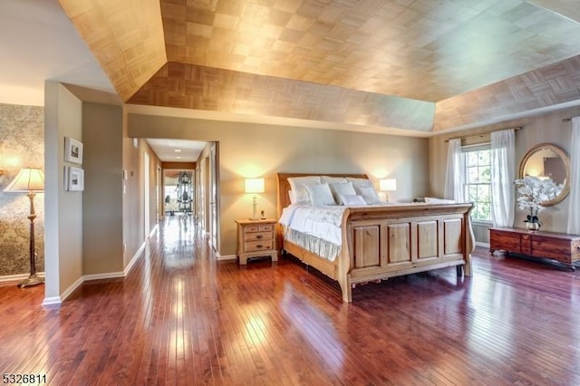 unfurnished bedroom featuring dark hardwood / wood-style flooring and lofted ceiling