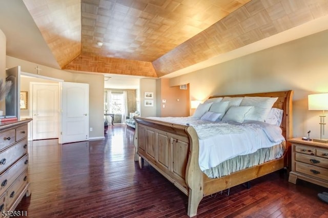 bedroom featuring lofted ceiling and dark hardwood / wood-style floors