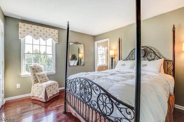 bedroom featuring dark hardwood / wood-style floors and multiple windows