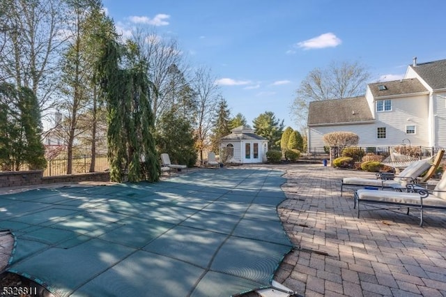 view of swimming pool with a patio area and an outbuilding