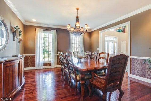 dining room featuring ornamental molding, an inviting chandelier, and dark wood-type flooring