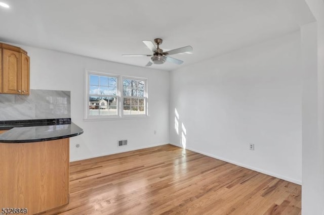 unfurnished living room with ceiling fan and light hardwood / wood-style floors