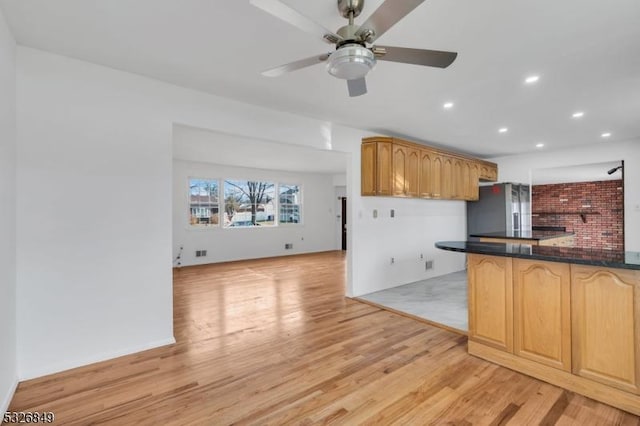 kitchen featuring stainless steel fridge, ceiling fan, and light hardwood / wood-style floors