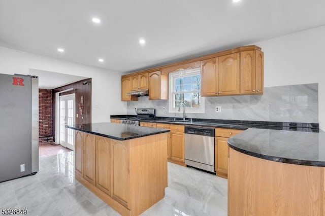 kitchen with sink, french doors, stainless steel appliances, decorative backsplash, and a kitchen island