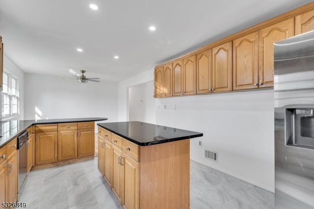 kitchen with ceiling fan, a center island, and stainless steel appliances