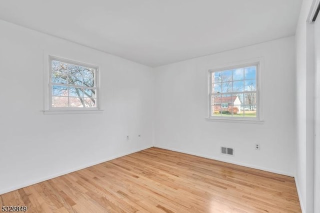 empty room with light hardwood / wood-style floors