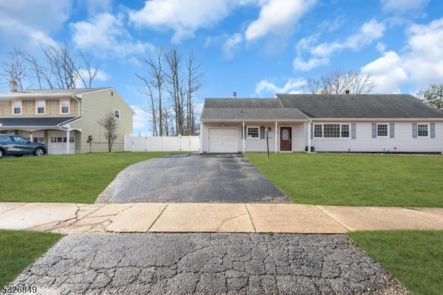 view of front of property featuring a front yard and a garage