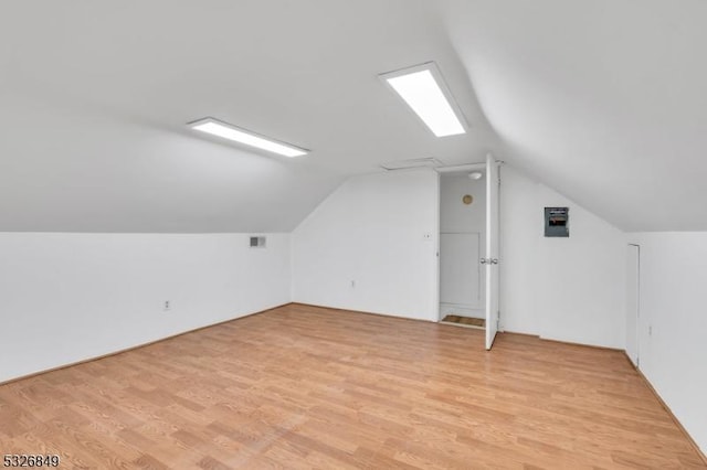 bonus room featuring light hardwood / wood-style floors and vaulted ceiling