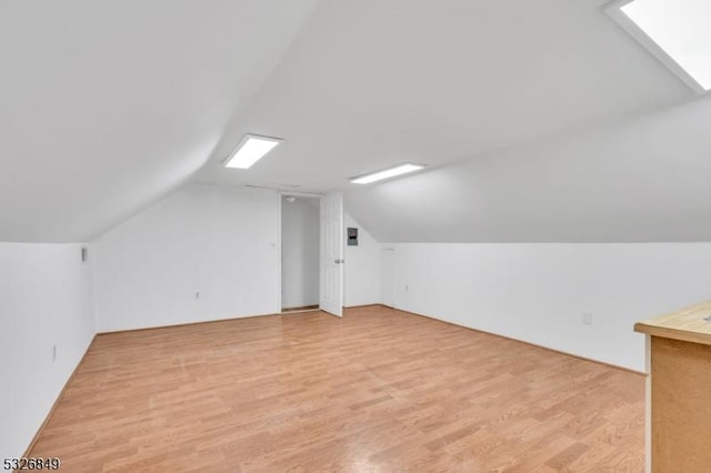 bonus room with light hardwood / wood-style flooring and lofted ceiling