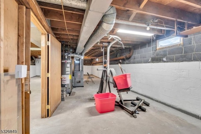 basement featuring heating unit and water heater