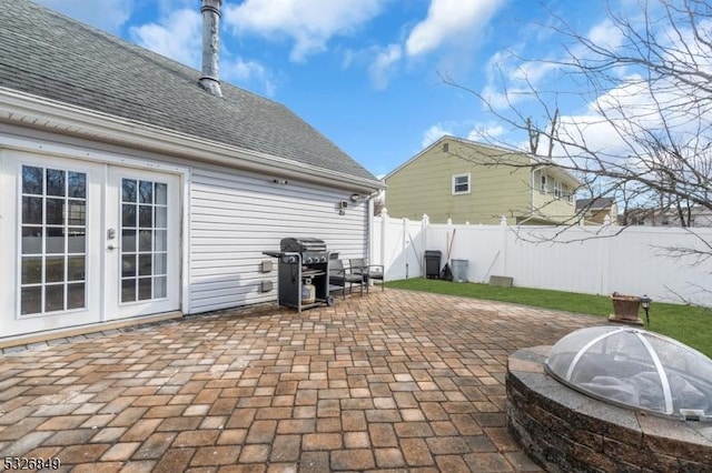 view of patio with french doors, area for grilling, and a fire pit