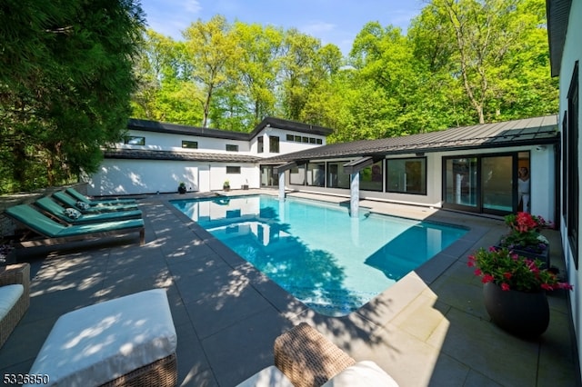 view of swimming pool featuring a patio