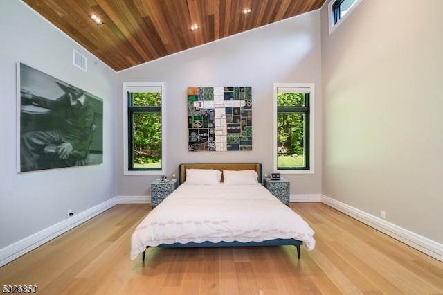 bedroom featuring light wood-type flooring, high vaulted ceiling, and wooden ceiling