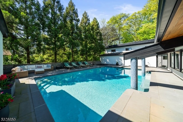 view of pool with an outdoor living space and a patio area