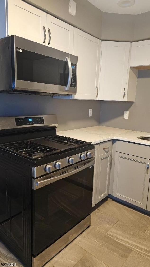 kitchen with appliances with stainless steel finishes and white cabinetry