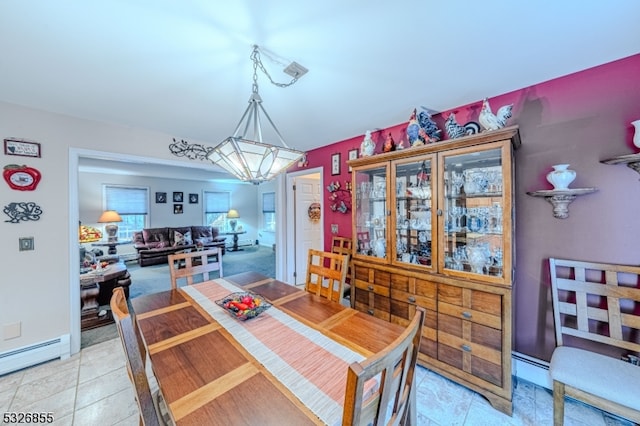 tiled dining room with a baseboard radiator