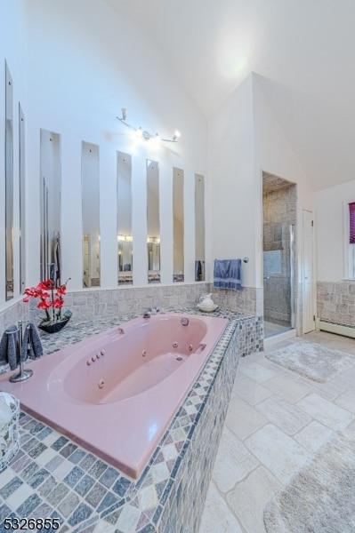 bathroom featuring separate shower and tub and high vaulted ceiling