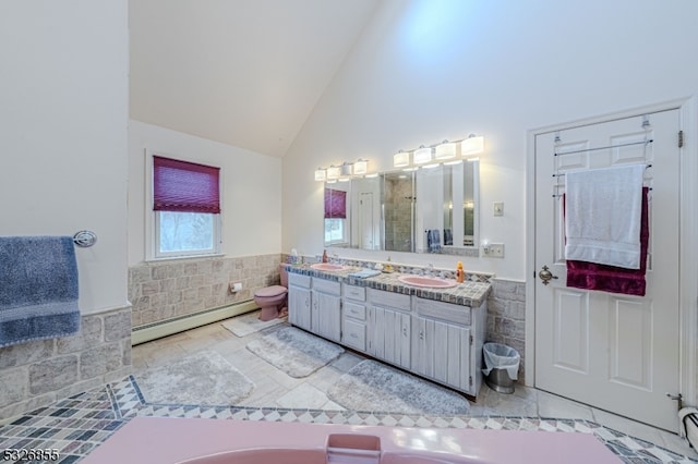 bathroom featuring vanity, tile patterned flooring, high vaulted ceiling, and a baseboard heating unit