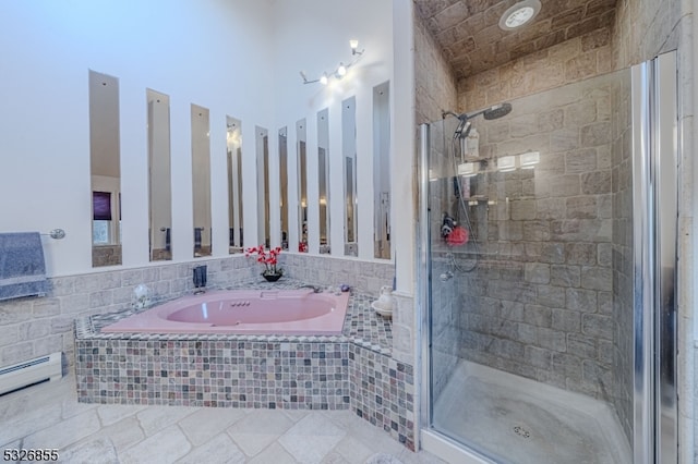 bathroom featuring separate shower and tub and a baseboard radiator