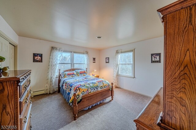 bedroom featuring carpet flooring, multiple windows, and a baseboard radiator