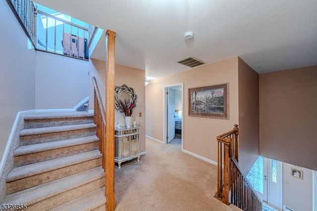 stairs featuring carpet flooring and plenty of natural light