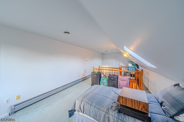 carpeted bedroom with lofted ceiling with skylight and baseboard heating