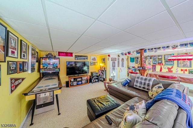 carpeted living room featuring a paneled ceiling